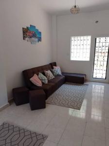 a living room with a brown couch in a room at 2 bedrooms private townhouse in Zayed in Sheikh Zayed
