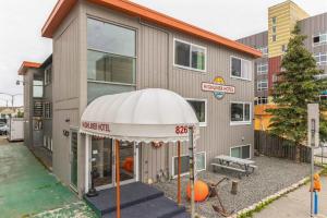 a building with an umbrella in front of it at Highliner Hotel - King Rooms with City & Park Views in Anchorage