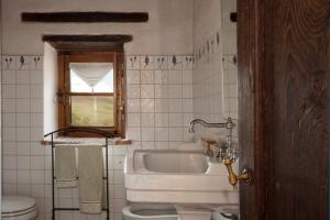 a white bathroom with a sink and a toilet at VILLA DI GRAZIELLA in Montisi
