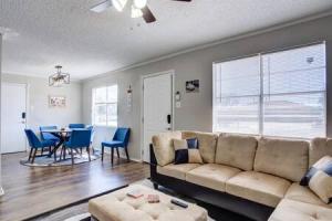 een woonkamer met een bank en een tafel en stoelen bij La Palma Lodge Near Texas Tech and Top Restaurants in Lubbock