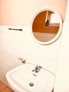 a bathroom with a sink and a mirror at Bunkhouse in Kandy