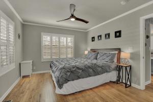 a bedroom with a bed and a ceiling fan at Luxury Mid Century Charmer Near Historic Main St in Fredericksburg
