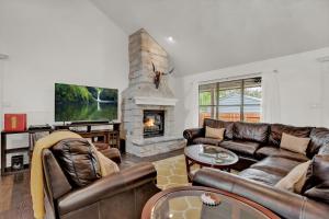a living room with a couch and a fireplace at Luxury Haus - GREAT Backyard, Firepit, Bocce Ball! in Fredericksburg