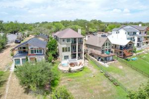 an aerial view of a house with a yard at Luxury Lakefront Home-Private Dock - Dipping Pool! in Spicewood
