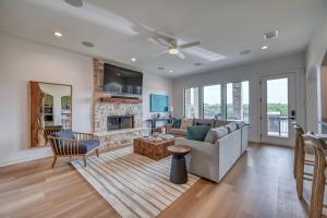a living room with a couch and a fireplace at Luxury Lakefront Home-Private Dock - Dipping Pool! in Spicewood
