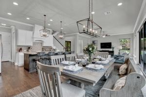 a dining room and kitchen with a table and chairs at Stunning Luxury Lake Home with Waterfront & Dock! in Horseshoe Bay