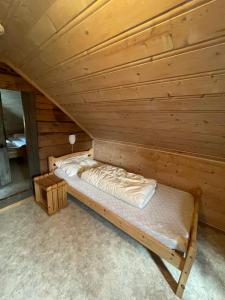 a wooden cabin with a bed in a room at Kvam - Stegastein in Aurland