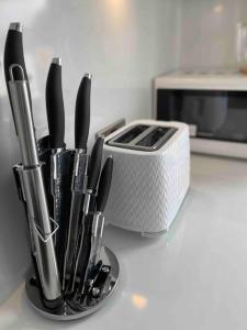 a kitchen counter with a knife holder and a toaster at Studio Apartment In Brighton & Hove in Brighton & Hove
