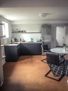 a kitchen with a table and chairs in a room at WINETIME in Oberhausen +12 photos