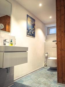 a bathroom with a sink and a toilet at WINETIME in Oberhausen +12 photos