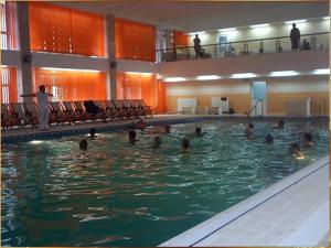 a group of people swimming in a swimming pool at Hotel Doina in Neptun