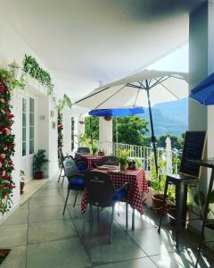 a patio with a table and chairs and an umbrella at El nido del Chorro in Málaga