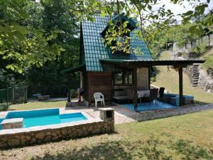 a house with a swimming pool in the yard at Koliba TAMAN in Konjic