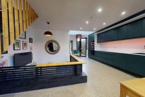 a kitchen with green cabinets and a bench at Stylish house in Dublin in Dublin