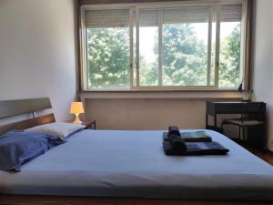 a bedroom with a large bed with a window at DISCOVER PORTO - Boavista in Porto