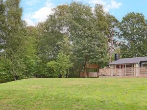 a large yard with a house in the background at Holiday home STENINGE in Steninge