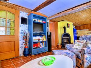 a living room with a table and a tv and a fireplace at Cosy holiday home in the Harz region in Herzberg am Harz