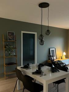 a dining room with a white table and chairs at Tikka Apartments in Jyväskylä