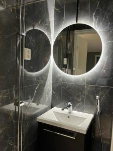 a bathroom with a sink and a mirror at Tikka Apartments in Jyväskylä +5 photos