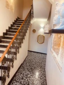 a staircase with black and white flooring and a stair case at B&B Meliora Rooms in Avola