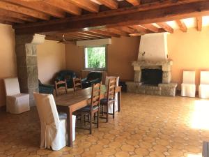 a dining room with a table and a fireplace at Le Moulin de Crampaux in Mansigné +20 photos