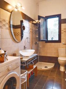 a bathroom with a sink and a washing machine at Meraki apartment in Zenempisátika