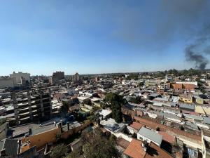 una vista aérea de una ciudad con edificios y humo en departamento minimalista en barrio sur en San Miguel de Tucumán