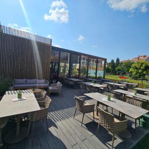 a patio with tables and chairs and a building at Santa Villa & restaurant in Sremska Mitrovica