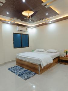 a bedroom with a bed and a tv on the ceiling at The Royal Sahdeo Venue in Gaya