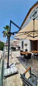 a patio with tables and umbrellas and tables at Nilus Boutique Hotel in Urla