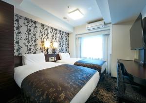 Кровать или кровати в номере APA Hotel Osaka Tanimachi Yonchome-Ekimae