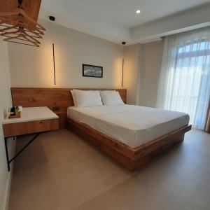 a bedroom with a large bed and a table and a window at Nilus Boutique Hotel in Urla