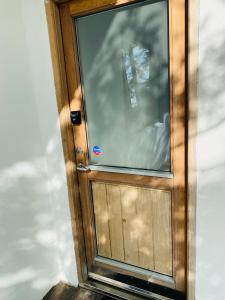 a wooden door with a reflection of a person in it at Easy Stay in Keflavík