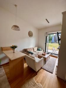 a living room with a couch and a table at Srna Apartment - Bjelašnica in Bjelašnica