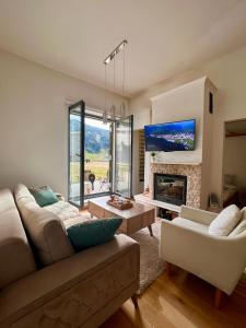 a living room with a couch and a fireplace at Srna Apartment - Bjelašnica in Bjelašnica