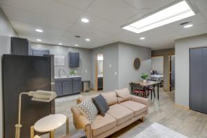 a living room with a couch and a kitchen at Modern Yankton Apartment Near Riverside Park! in Yankton
