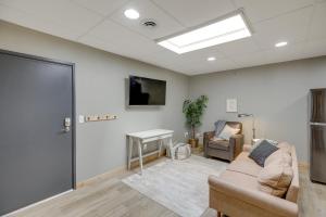 a living room with a couch and a table at Modern Yankton Apartment Near Riverside Park! in Yankton