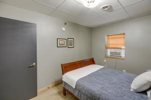 a bedroom with a bed and a window at Modern Yankton Apartment Near Riverside Park! in Yankton