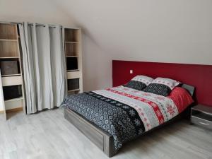 1 dormitorio con 1 cama con cabecero rojo en Maison de campagne avec piscine 