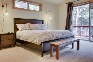 a bedroom with a bed and a table and a window at Tahoma Deluxe Brand New Home in Tahoma