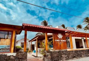 a restaurant with a sign that reads court inn at Hotel Coral Blanco with high speed internet Starlink in Puerto Villamil