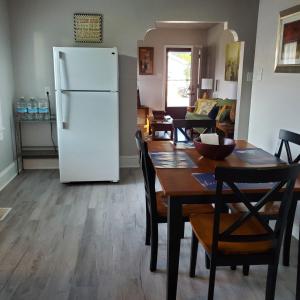 a kitchen with a table and a white refrigerator at Relaxing Stay Near the Beach in Hampton