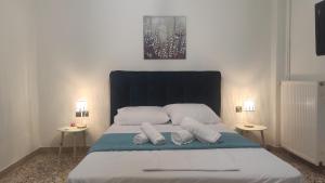 a bedroom with a bed with two night stands at City Apartment w3 BR spacious yard in Eretria