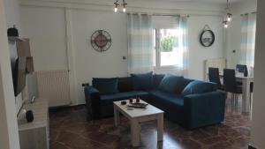 a living room with a blue couch and a table at City Apartment w3 BR spacious yard in Eretria