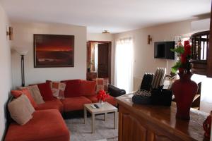 salon z czerwoną kanapą i stołem w obiekcie Apartman AS w Belgradzie