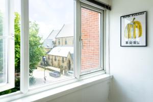 a window with a view of a church at 6bd Home-Contractors A+ Location in Sheffield