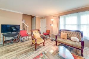 a living room with chairs and a flat screen tv at Cozy North Carolina Retreat Near Beaches and Golfing in Jacksonville