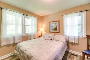 a bedroom with a bed and two windows at Cozy North Carolina Retreat Near Beaches and Golfing in Jacksonville