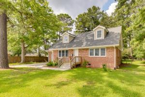 a brick house with a porch and a yard at Cozy North Carolina Retreat Near Beaches and Golfing in Jacksonville