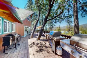 a deck with two bbqs and a grill at Bass Lake Lodge in Bass Lake